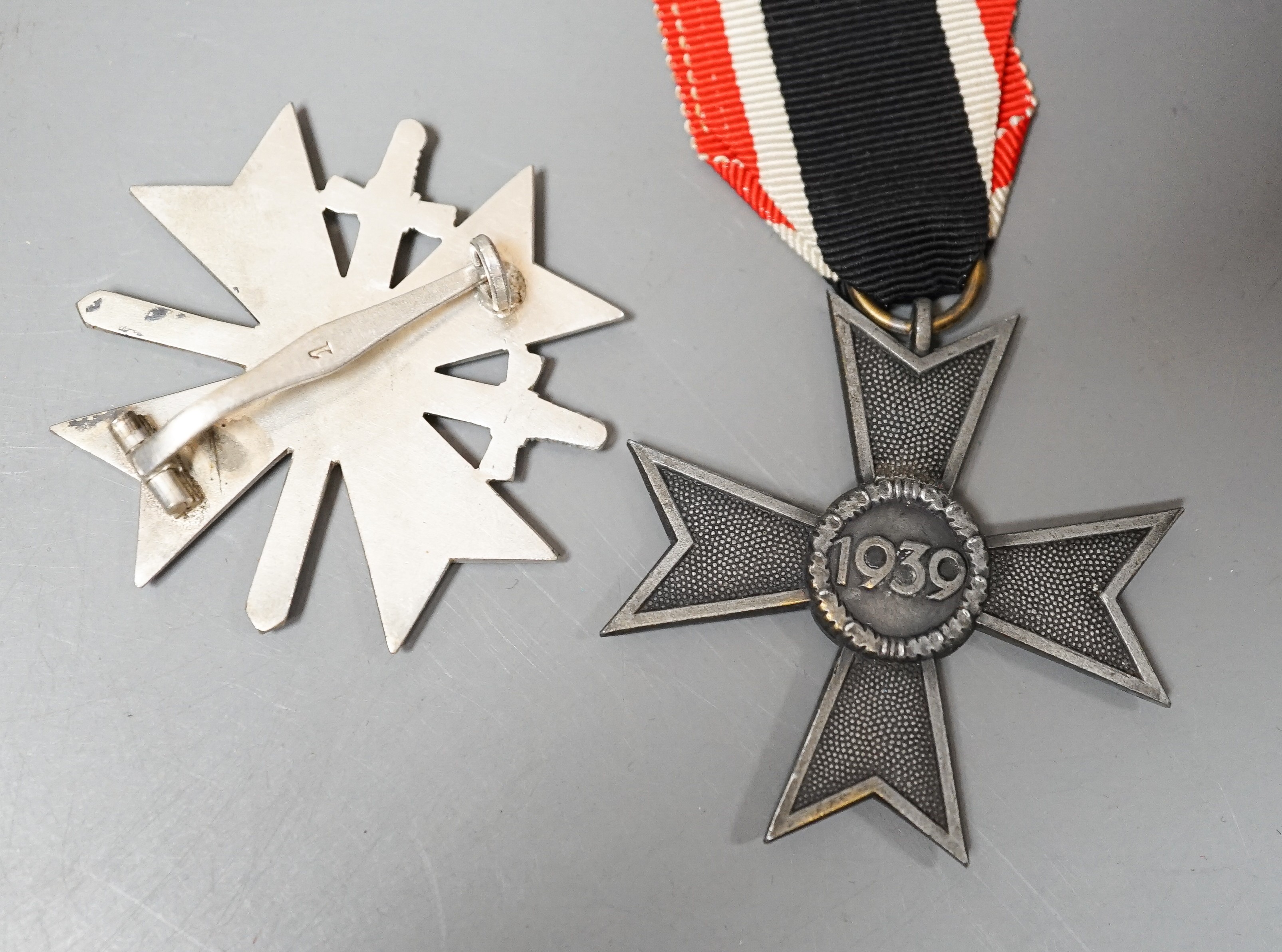 A WW2 German War Merit Cross 1st Class With Swords, stamped 1, a War Merit Cross 2nd Class Without Swords